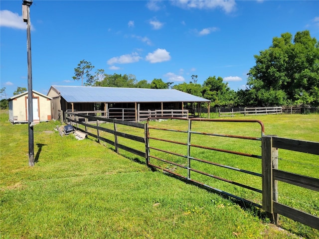 exterior space featuring a rural view and an outdoor structure