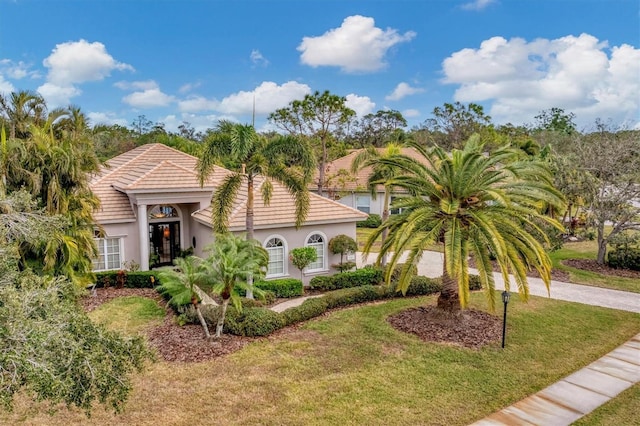 mediterranean / spanish house featuring a front yard