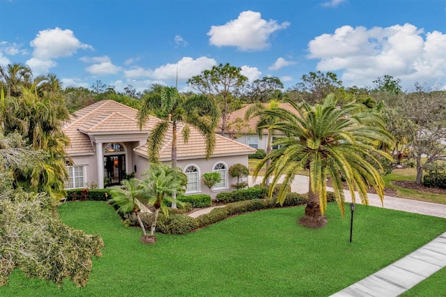 mediterranean / spanish house with a front lawn