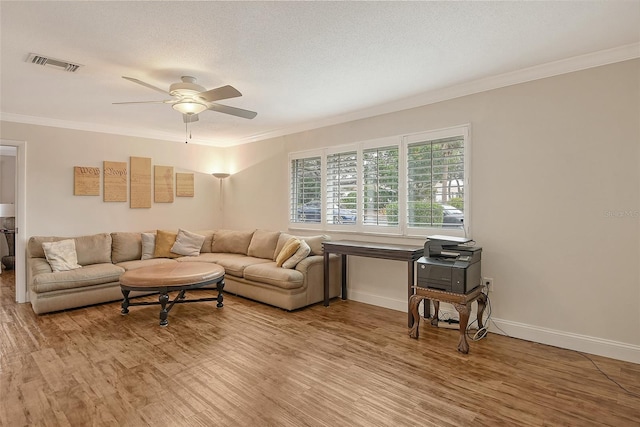 living room featuring hardwood / wood-style flooring, ornamental molding, and ceiling fan