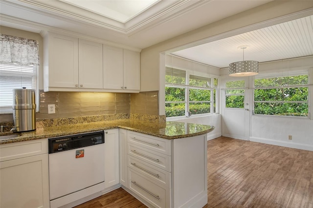 kitchen featuring dark stone countertops, dishwasher, white cabinets, and decorative light fixtures