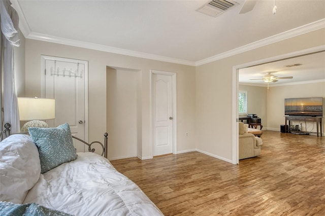 bedroom featuring ceiling fan, hardwood / wood-style flooring, and ornamental molding