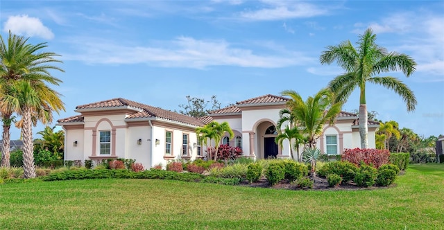 mediterranean / spanish house with a front yard