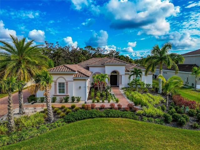 mediterranean / spanish home featuring a front yard