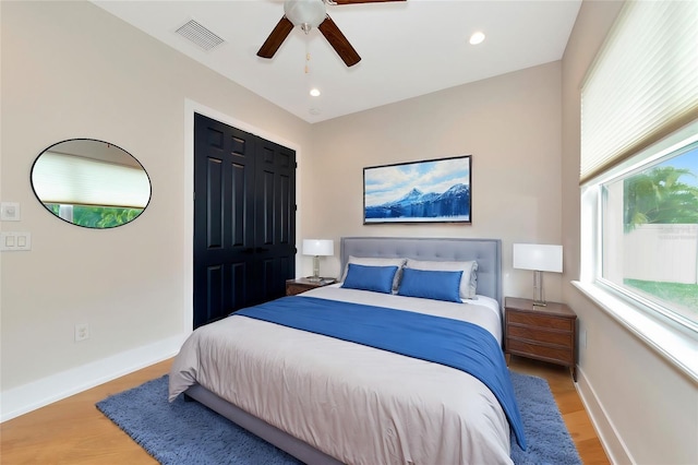 bedroom with ceiling fan, a closet, and wood-type flooring