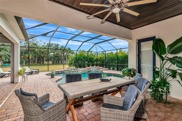 view of patio / terrace featuring a lanai, a pool with hot tub, and ceiling fan