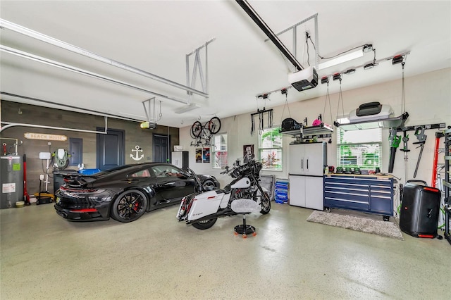 garage featuring a garage door opener and electric water heater