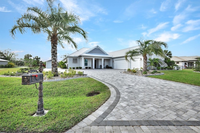 view of front of property with a garage and a front yard