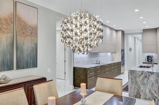 dining room featuring sink and a chandelier