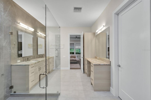 bathroom with ceiling fan, an enclosed shower, and vanity