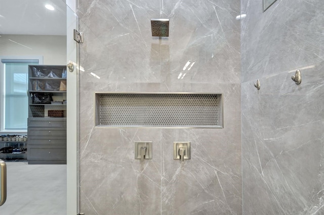 bathroom featuring a shower with shower door