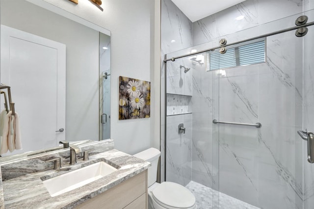 bathroom with toilet, vanity, and an enclosed shower