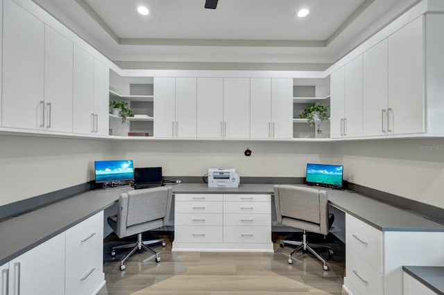 home office featuring built in desk and light hardwood / wood-style flooring