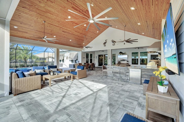 exterior space featuring ceiling fan, outdoor lounge area, glass enclosure, and area for grilling