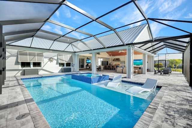 view of swimming pool with glass enclosure, a patio area, an in ground hot tub, ceiling fan, and an outdoor living space