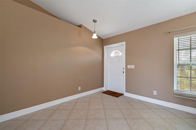 foyer with vaulted ceiling and light tile patterned floors