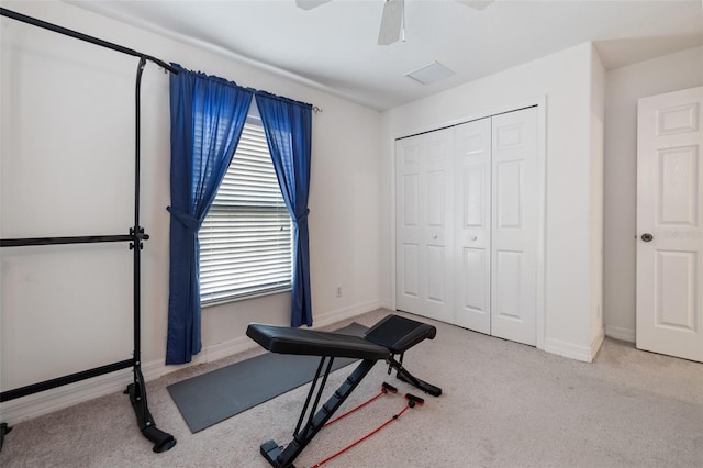 exercise room featuring light carpet and ceiling fan