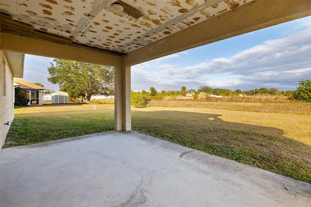 view of patio with a shed