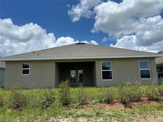 2648 Averland Loop, North Port, FL 34287 - rear view of property featuring stucco siding and a shingled roof