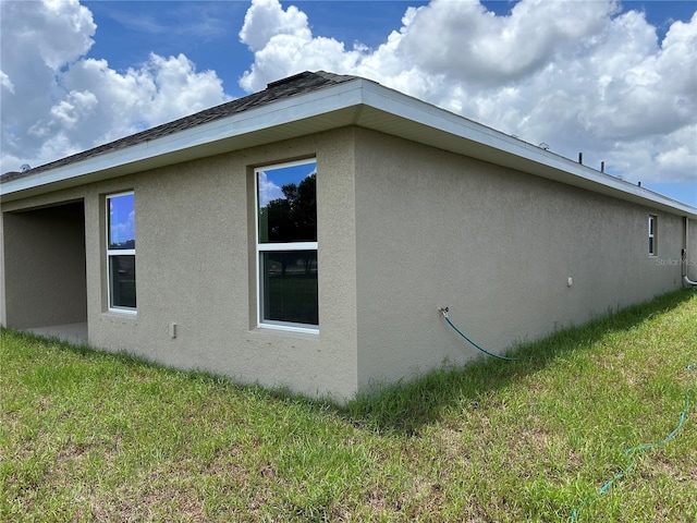 2648 Averland Loop, North Port, FL 34287 - view of property exterior featuring stucco siding and a lawn