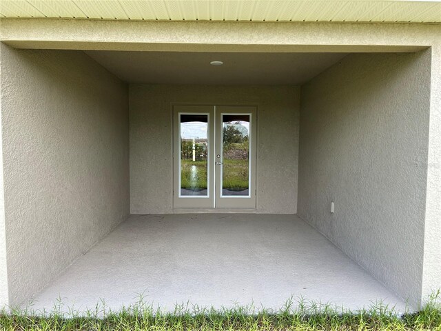 2648 Averland Loop, North Port, FL 34287 - doorway to property with stucco siding, french doors, and a patio area
