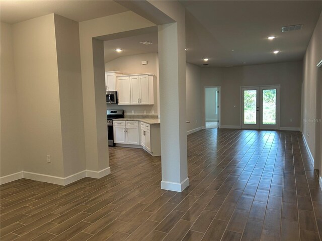 2648 Averland Loop, North Port, FL 34287 - kitchen featuring stainless steel appliances, dark wood-style flooring, open floor plan, white cabinetry, and recessed lighting