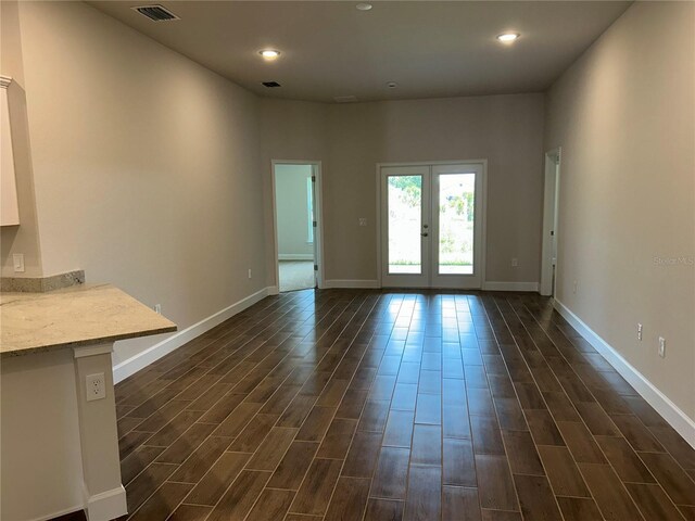 2648 Averland Loop, North Port, FL 34287 - unfurnished living room with french doors, dark wood-type flooring, and recessed lighting