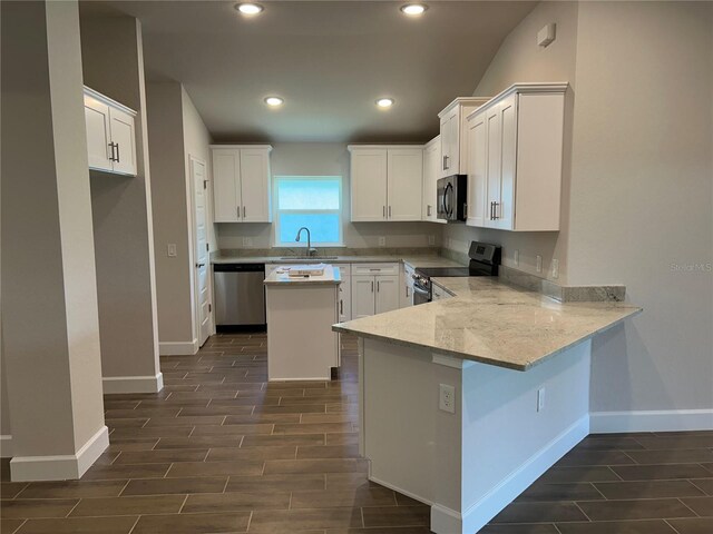 2648 Averland Loop, North Port, FL 34287 - kitchen featuring stainless steel appliances, wood tiled floors, white cabinetry, and recessed lighting