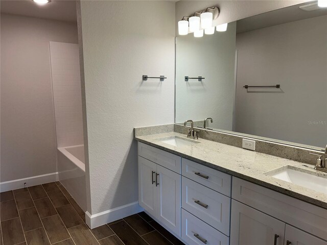 2648 Averland Loop, North Port, FL 34287 - bathroom with double vanity and wood tiled floors