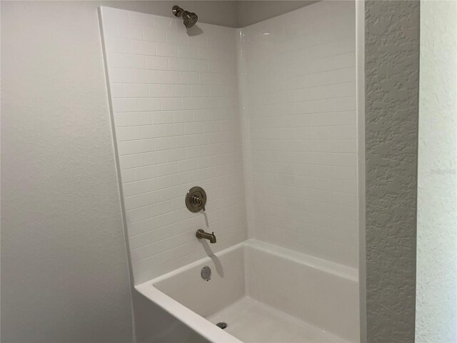 2648 Averland Loop, North Port, FL 34287 - bathroom featuring a textured wall and  shower combination