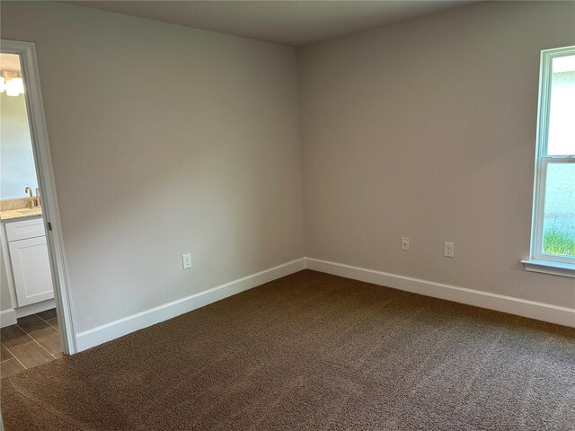 2648 Averland Loop, North Port, FL 34287 - spare room featuring baseboards and dark carpet