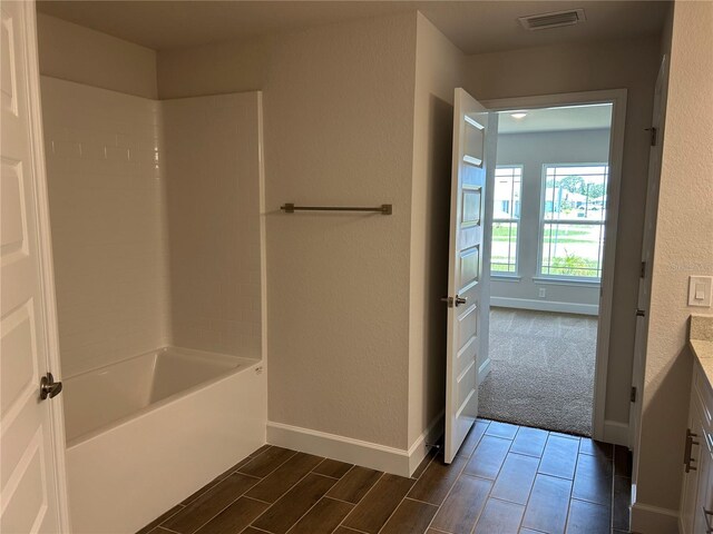2648 Averland Loop, North Port, FL 34287 - full bath with shower / washtub combination, vanity, a textured wall, and wood finished floors