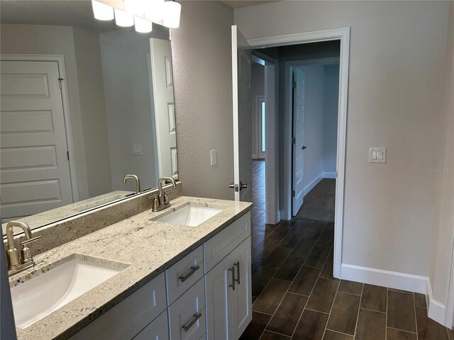 2648 Averland Loop, North Port, FL 34287 - full bathroom featuring double vanity and wood finish floors