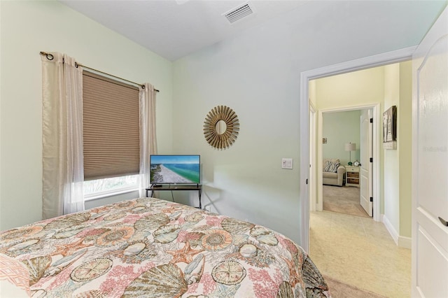 bedroom featuring light carpet