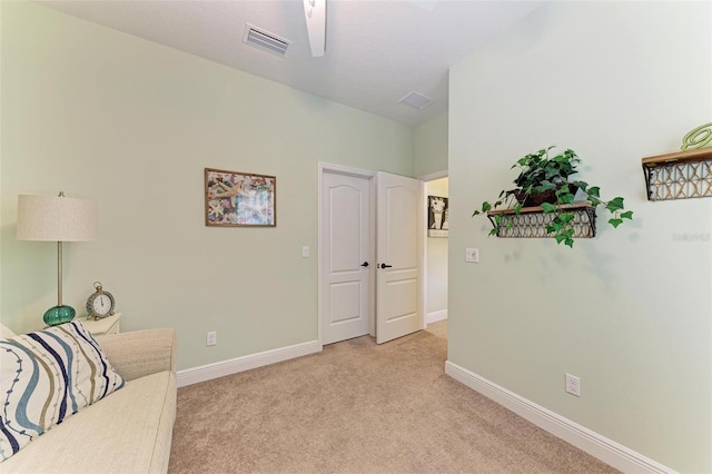 living area with light carpet