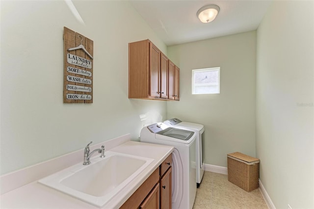 clothes washing area with sink, independent washer and dryer, and cabinets