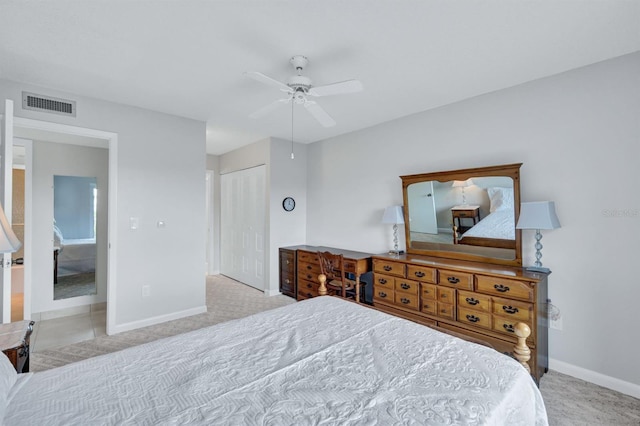 carpeted bedroom with ceiling fan and a closet