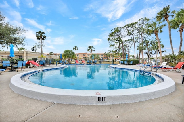 view of swimming pool with a patio area