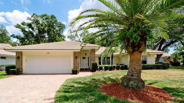 view of front facade with a garage and a front yard