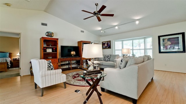 living room with ceiling fan, track lighting, light hardwood / wood-style flooring, and lofted ceiling