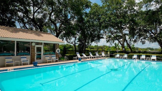 view of swimming pool with an outdoor structure