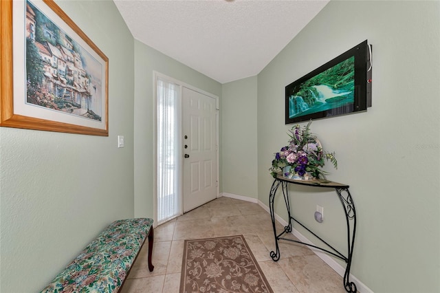 tiled entrance foyer with a textured ceiling