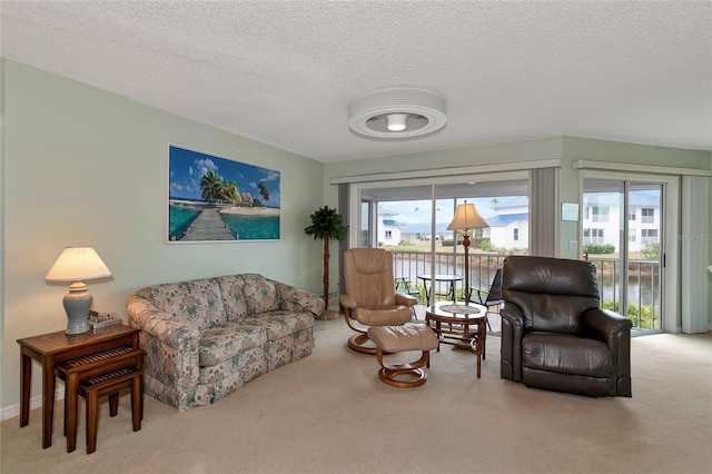 living room featuring a water view, carpet floors, and a textured ceiling