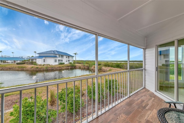 unfurnished sunroom with a water view