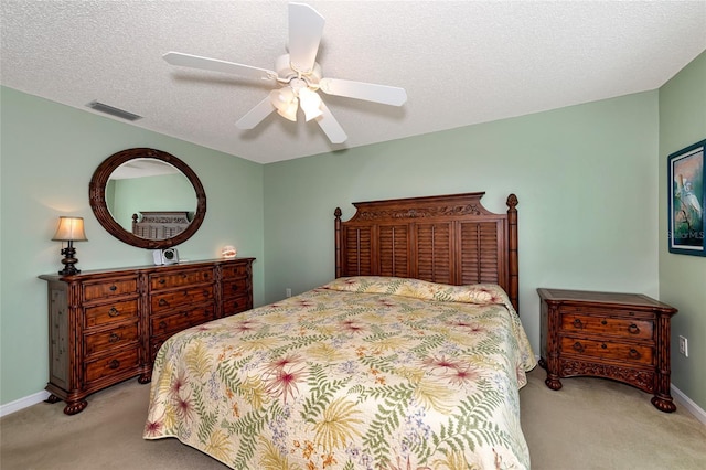 bedroom with light carpet, a textured ceiling, and ceiling fan