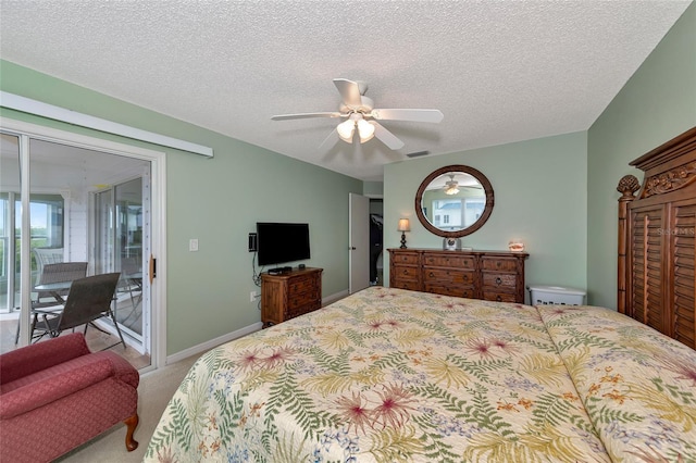 bedroom with access to exterior, a textured ceiling, ceiling fan, and carpet