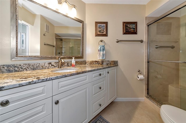 bathroom featuring vanity, toilet, an enclosed shower, and tile patterned flooring