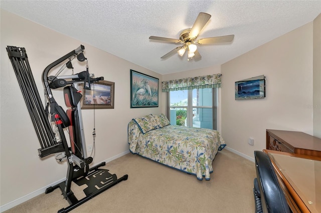 carpeted bedroom featuring ceiling fan and a textured ceiling