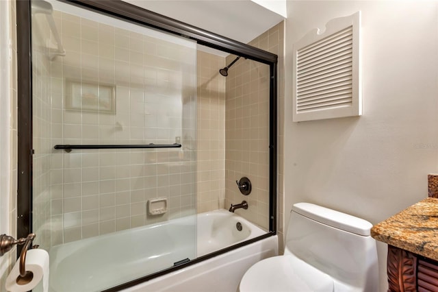 full bathroom with shower / bath combination with glass door, vanity, and toilet