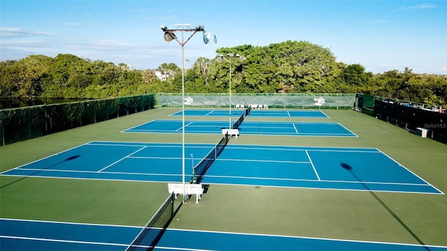 view of tennis court featuring basketball hoop